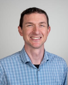 A headshot of a man smiling at the camera.